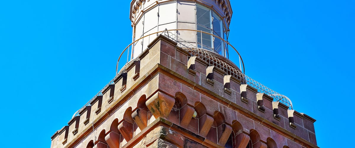 A historic tower with a rounded top and arched windows.