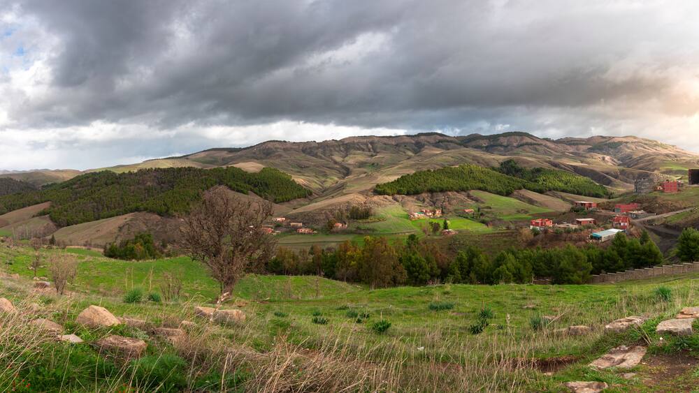 landscape photo in mountains with beautiful sky and trees in roman town Cuicul at village Djemila, Algeria