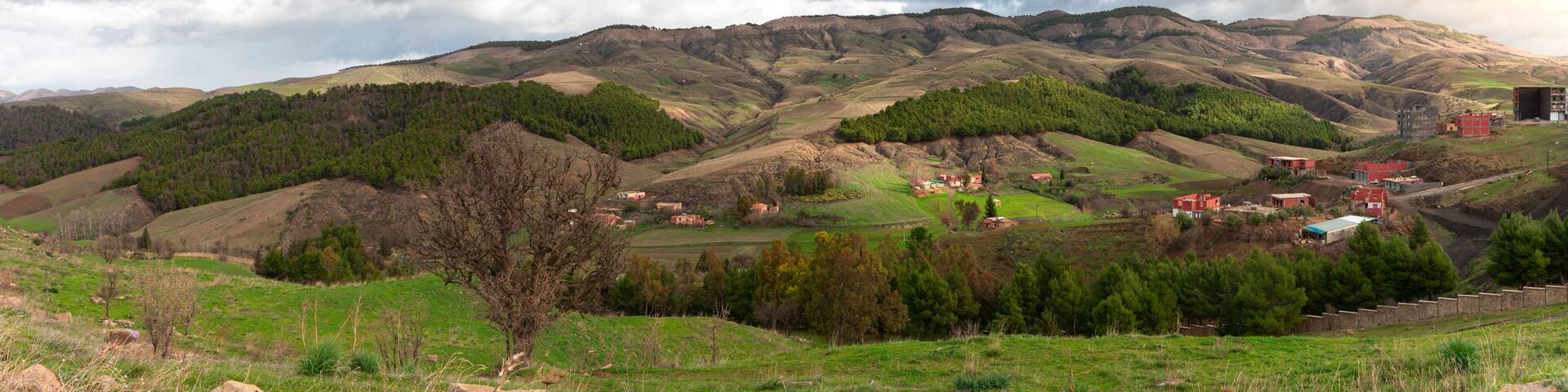 landscape photo in mountains with beautiful sky and trees in roman town Cuicul at village Djemila, Algeria