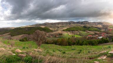 landscape photo in mountains with beautiful sky and trees in roman town Cuicul at village Djemila, Algeria
