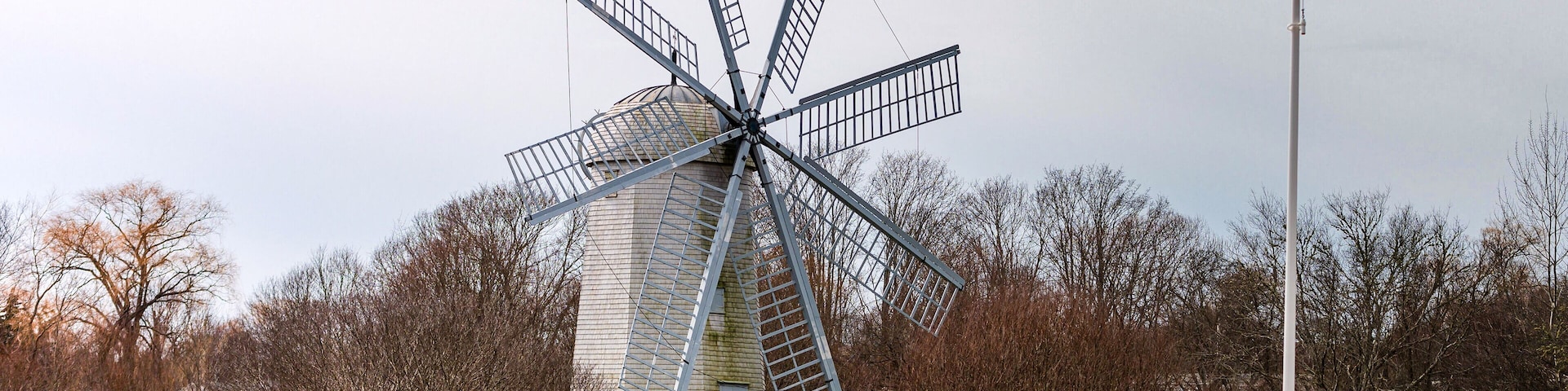 Boyd's Windmill, also known as Boyd's Wind Grist Mill, is a historic smock mill in Middletown, Rhode Island. John Peterson built the windmill in 1810, and William Boyd purchased it in 1815. It originally had four common sails, but four more were added by the family. The mill is a timber-frame structure, octagonal in shape, and about 30 feet (9.1 m) tall, with a rotating cap powered by eight vanes with canvas sheets.
The mill is located on a public area so the grounds are open. The windmill itself is open to the public on Sunday afternoons in July, August and September.
#windmill #travel