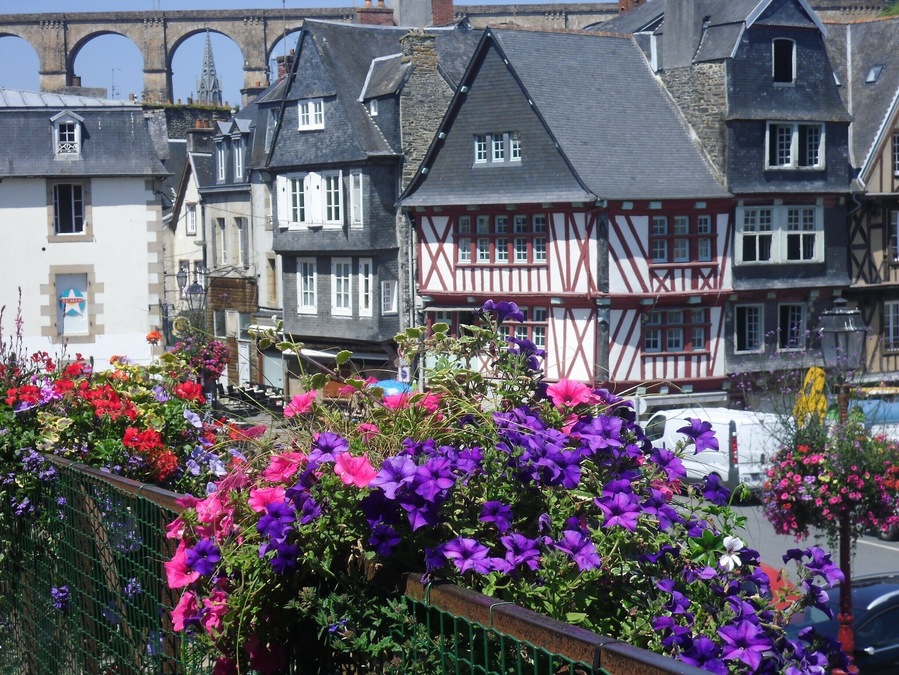 morlaix, Brittany in the summertime. Interesting, very histric with medieval buildings. There is an estuary with yachts and a magnificent viaduct which you can walk across to maximise views. Well worth the climb!