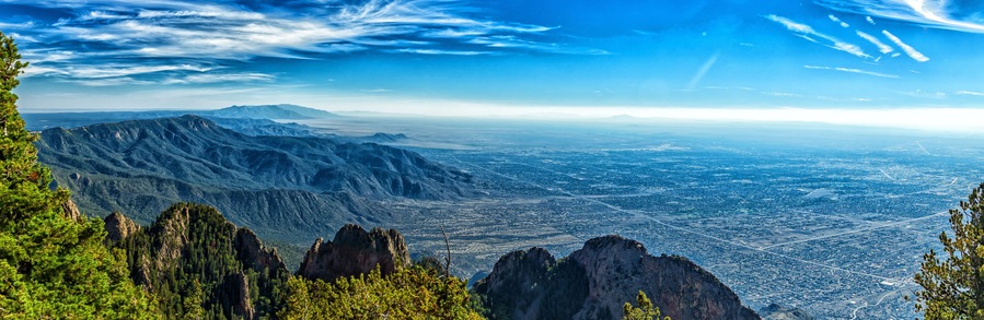 A mountainous landscape with a city in the valley below.