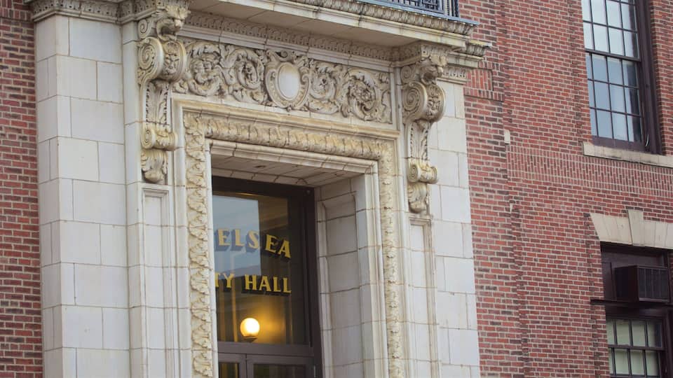 A building entrance with ornate carvings and a sign that reads "ELSEA HALL".