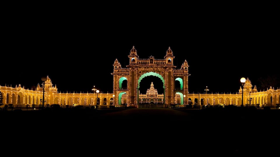 A grand illuminated building with domes and arches, likely a historical or cultural landmark.