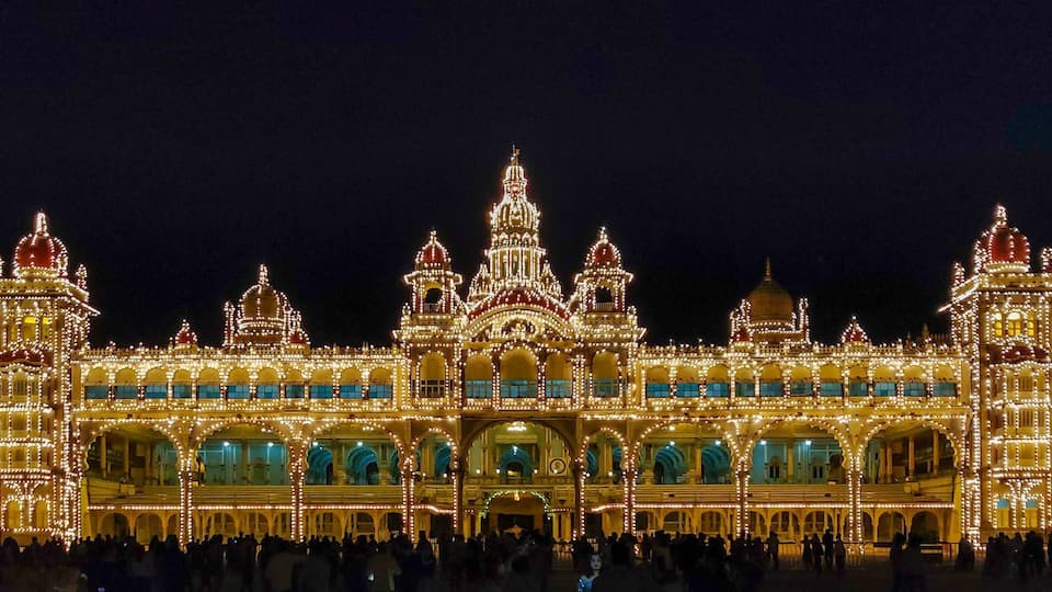 A grand, illuminated building with multiple domes and arches, likely a historical or cultural landmark.
