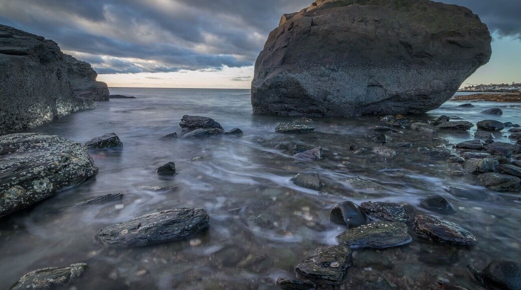 Wide angle long exposure shot at Anchor Beach in Milford Connecticut. Small town beach with the feeling of rocky Maine coastline.