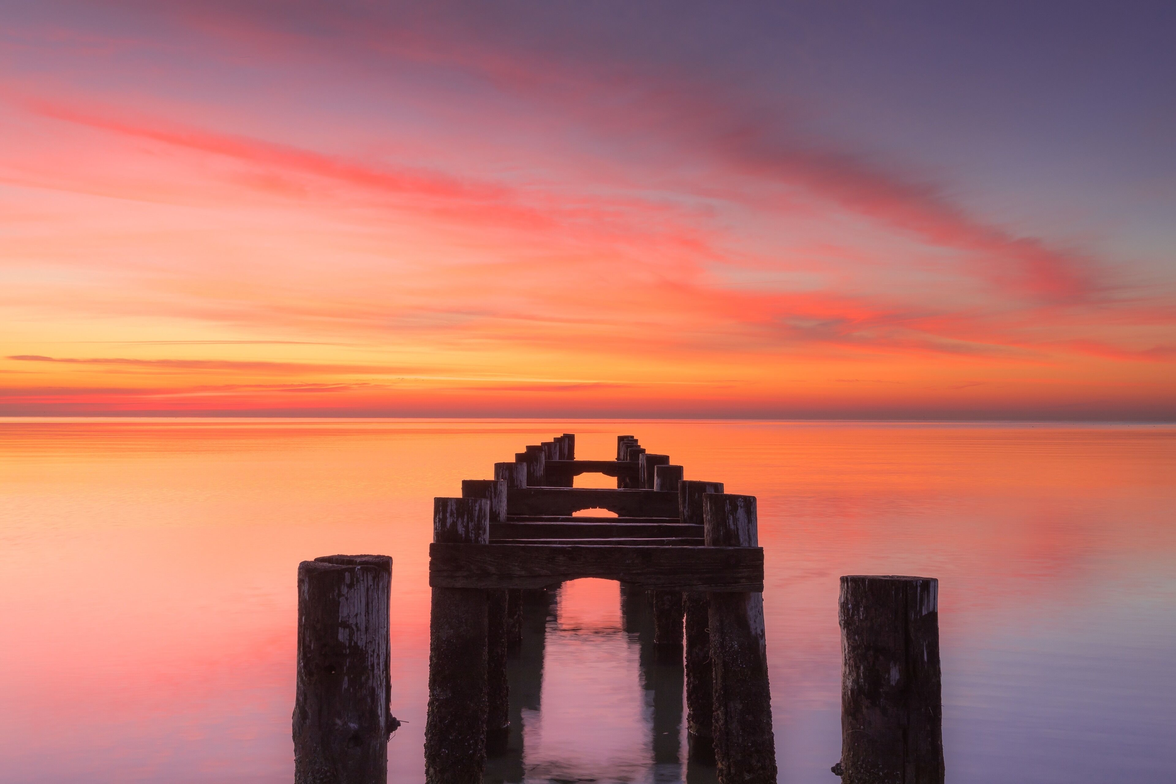 Angles and Composition wood pier poles at sunrise Walnut Beach Area Milford Connecticut