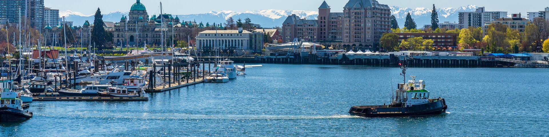 Victoria Inner Harbour. Historical buildings in the background over blue sky. Panoramic view.
