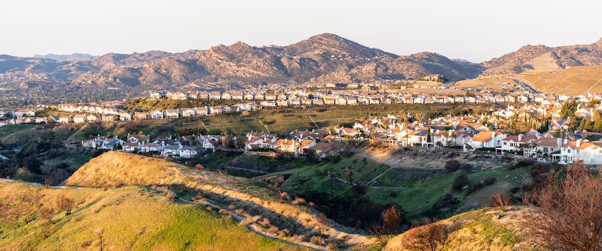 Hilltop houses overlooking the San Fernando Valley in northern Los Angeles, California. The Santa Susana Mountains are in the background.