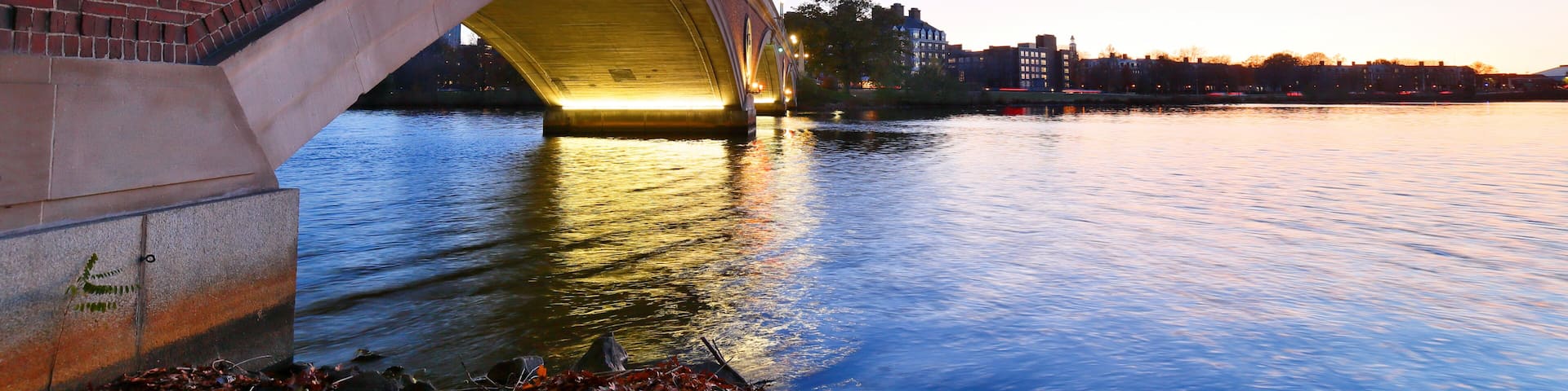 Dunster House and John Weeks Bridge on campus of Harvard University at sunset. Harvard University is a private Ivy League research university in Cambridge, MA.