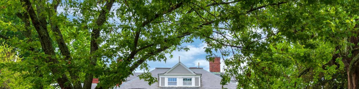 Elegant Victorian Home Framed by Lush Greenery and White Fence in Newton, Massachusetts, USA