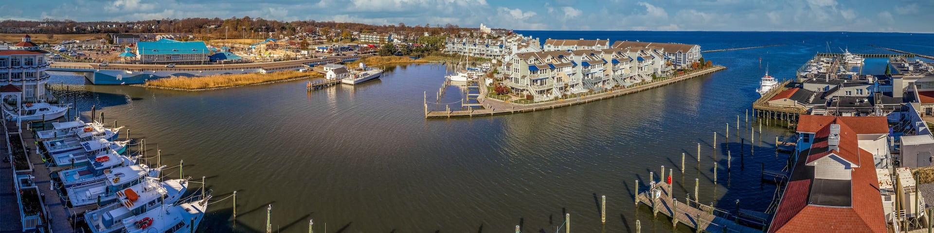 Aerial view of Chesapeake Beach marina with luxury sail boats, beach house apartments, fishing boats near the water park popular vacation spot for Washington residents in Calvery county Maryland