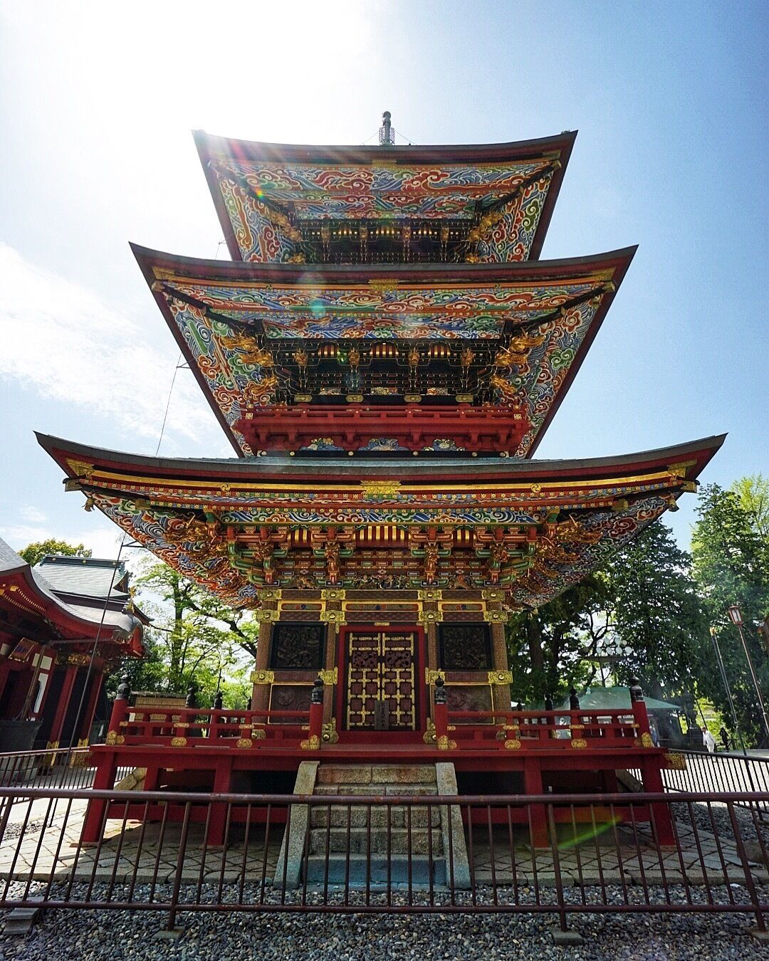 A multi-tiered pagoda with intricate roof designs and red and gold accents.