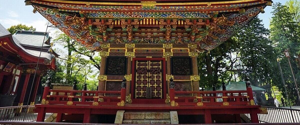 A multi-tiered pagoda with intricate roof designs and red and gold accents.