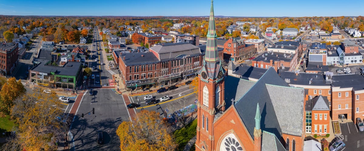 First Congregational Church aerial view in fall with foliage at 2 E Central Street in historic town center of Natick, Massachusetts MA, USA.