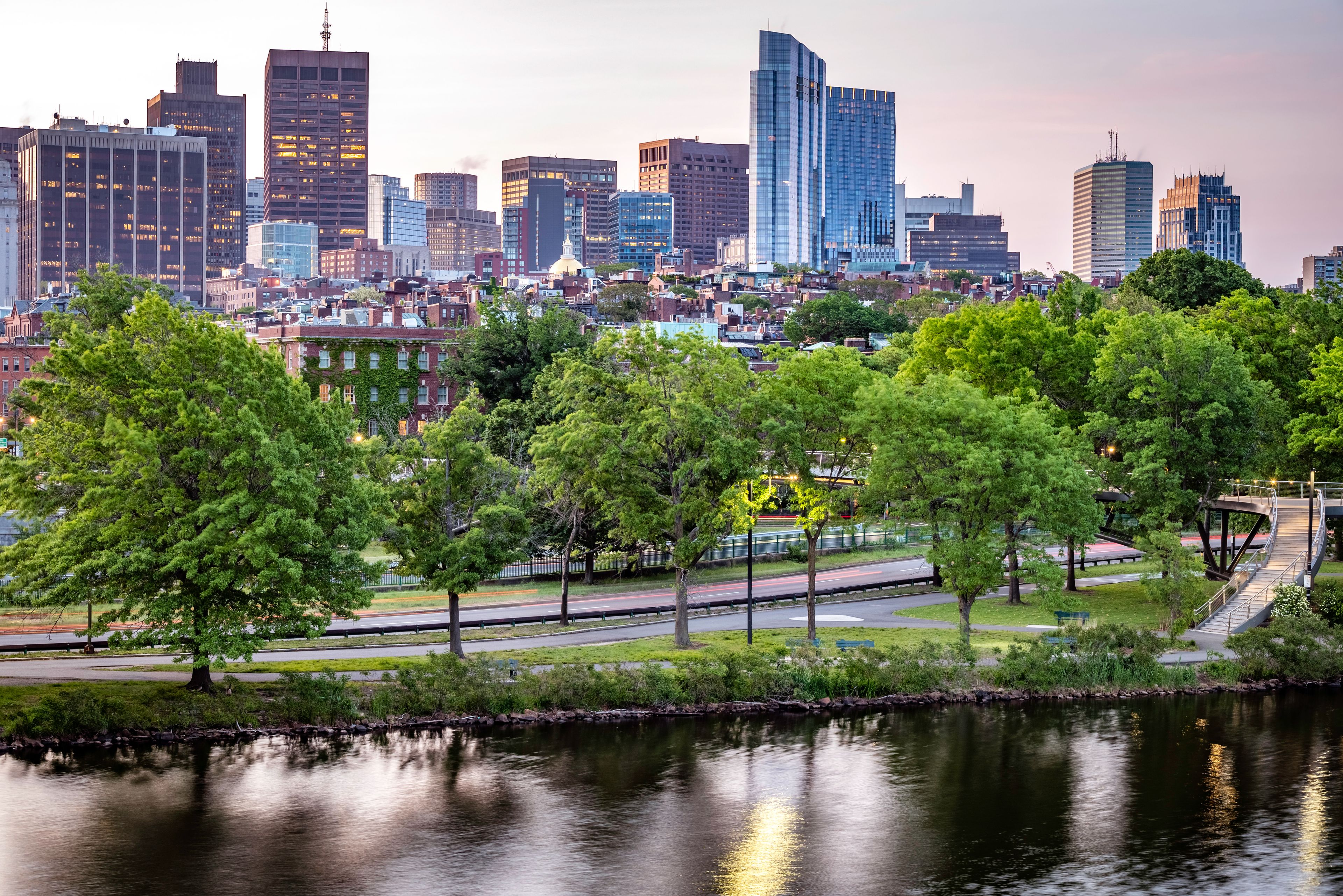 The city of Boston in the summer sun at sunrise at Backbay neighborhood with the Charles River and its mix of contemporary and historic buildings.