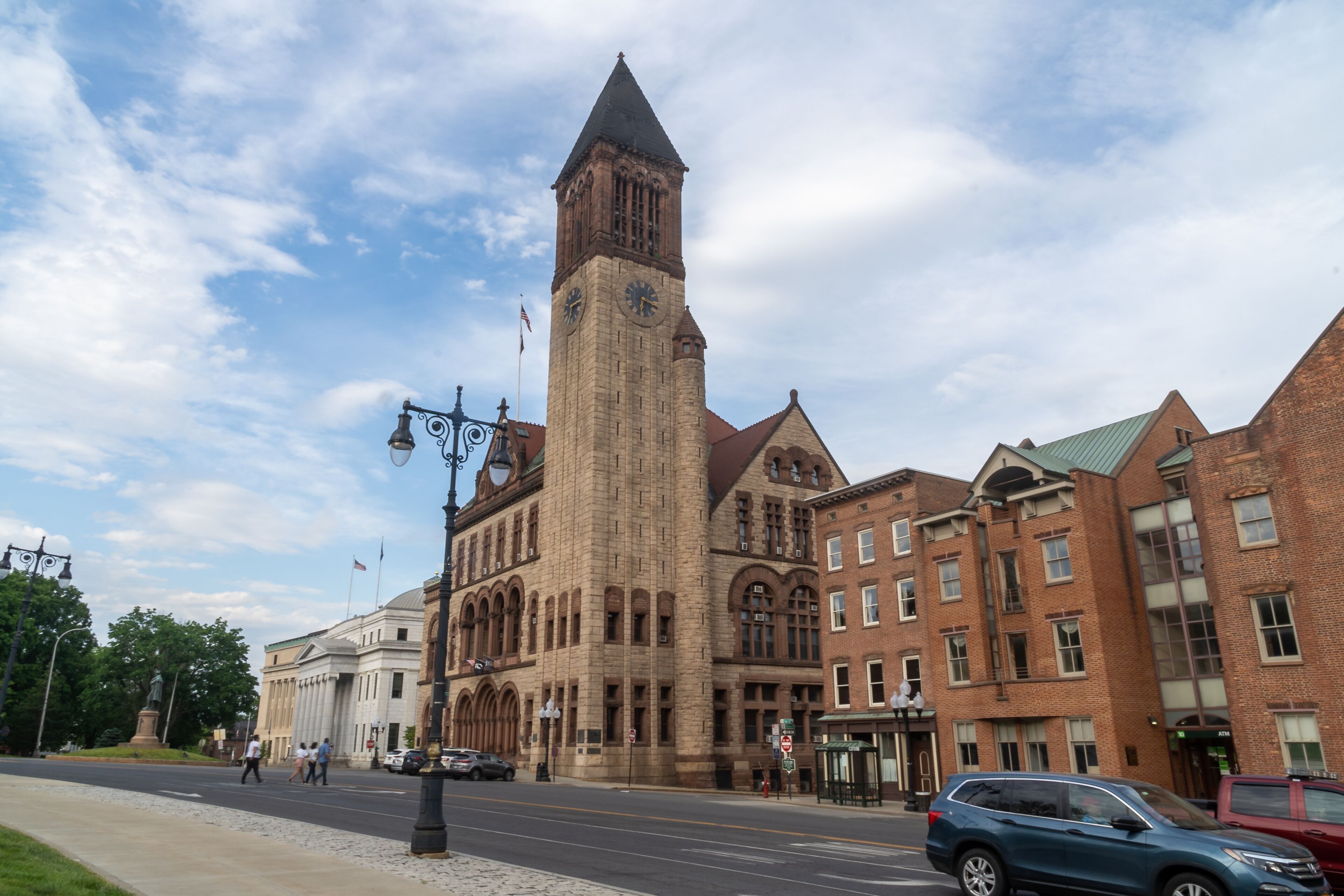 Albany, NY - USA - May 22, 2021: A landscape view of the historic Richardsonian Romanesque Albany City Hall, the seat of government of the city of Albany, New York. Featuring a 202-foot tall tower.