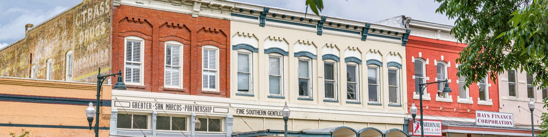 A row of historic buildings with storefronts, including a bank and a restaurant.