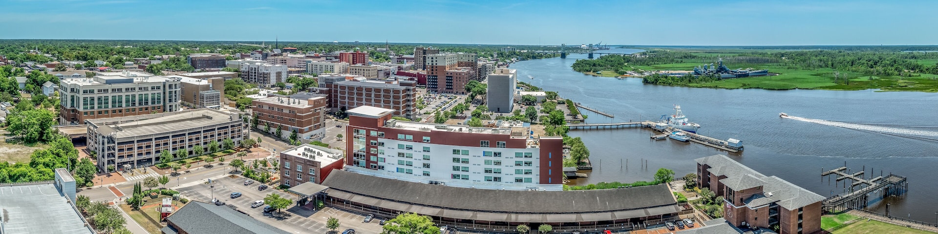 Aerial view of Wilmington North Carolina historic district along the Cape Fear river with cloudy sky