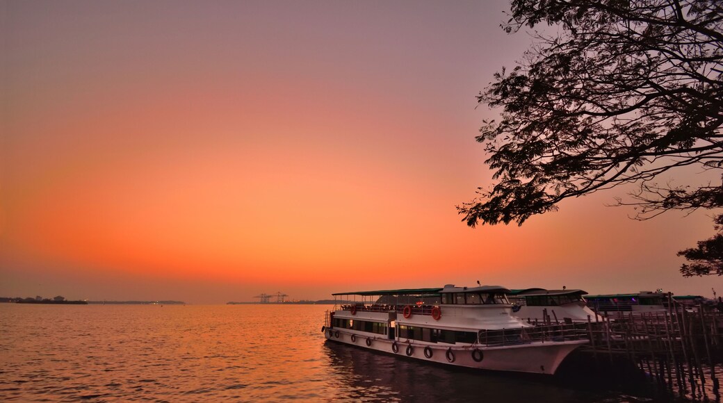 A ferry parked on the banks of Vembanad lake during sunset in Kochi