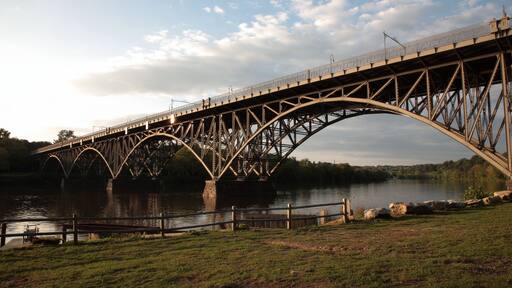 View of steel arch bridge Strawberry Mansion Bridge crossing the Schuylkill River in Fairmount Park under sunset in Philadelphia, Pennsylvania, USA