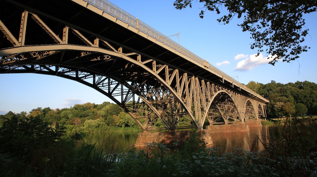View of steel arch bridge Strawberry Mansion Bridge crossing the Schuylkill River in Fairmount Park under sunset in Philadelphia, Pennsylvania, USA