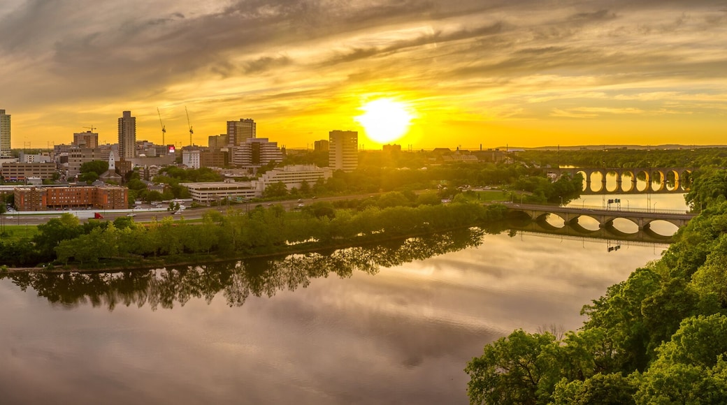 Aerial view of downtown New Brunswick and Rutgers University as the sun sets behind the high rise buildings and reflect on the Raritan river