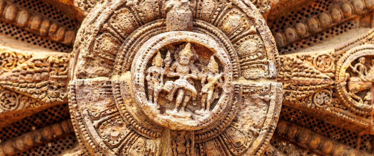 A detailed stone carving with intricate patterns and a central circular motif.