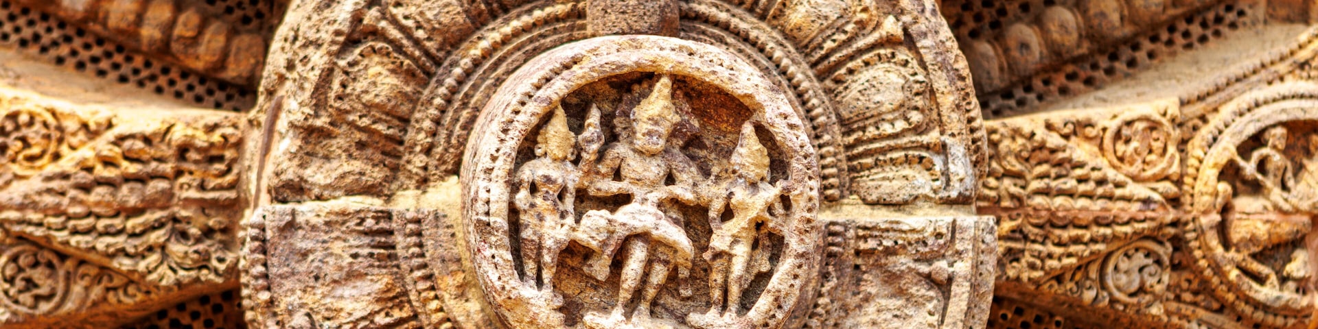 A detailed stone carving with intricate patterns and a central circular motif.