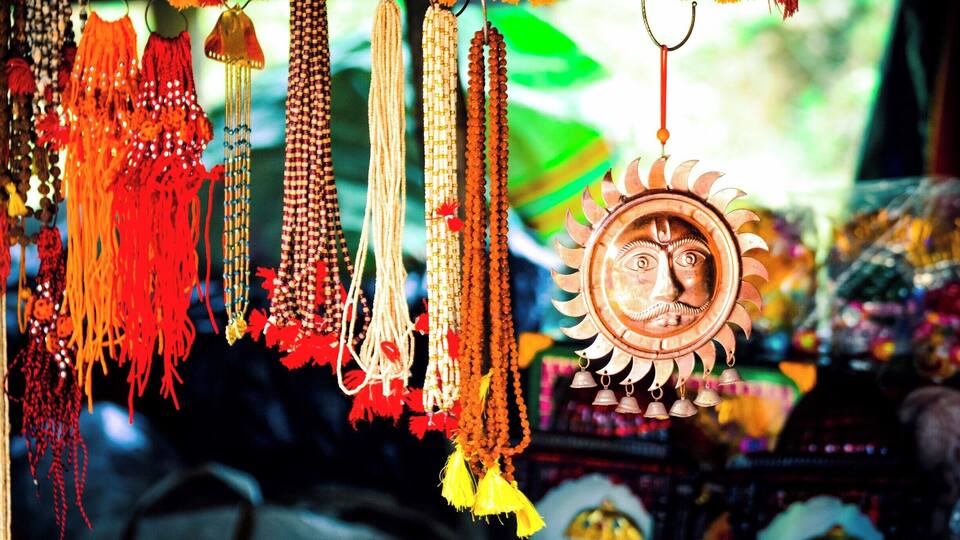 A variety of colorful prayer beads and a decorative sun-shaped ornament.