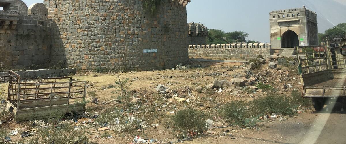 A historic stone fort with battlements and a large gateway.