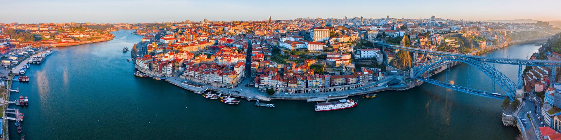 Porto Cityscape with Dom Luis I Bridge over Douro River and medieval Ribeira district at sunset, Portugal