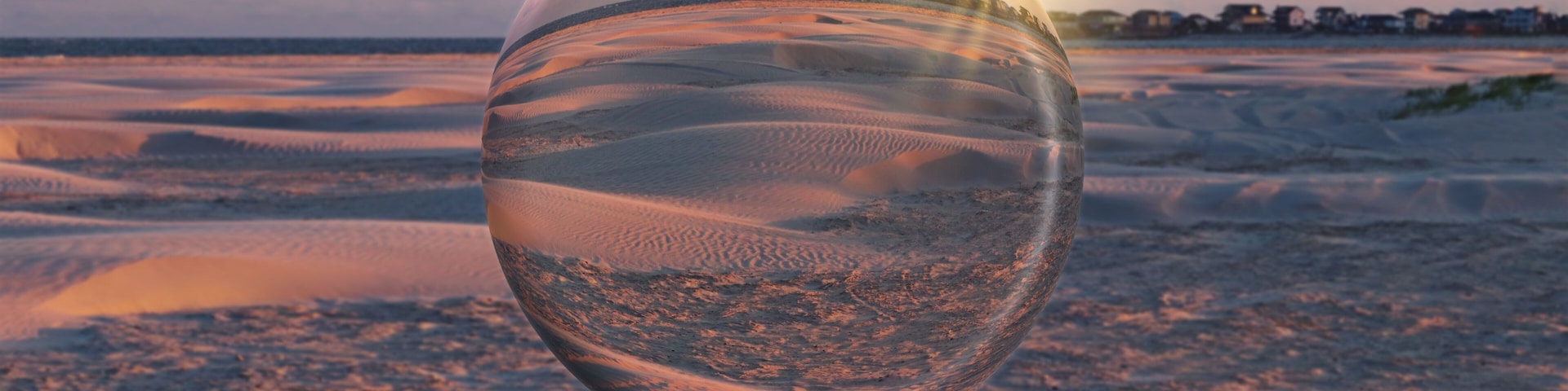 A desert landscape with sand dunes and a clear sky.