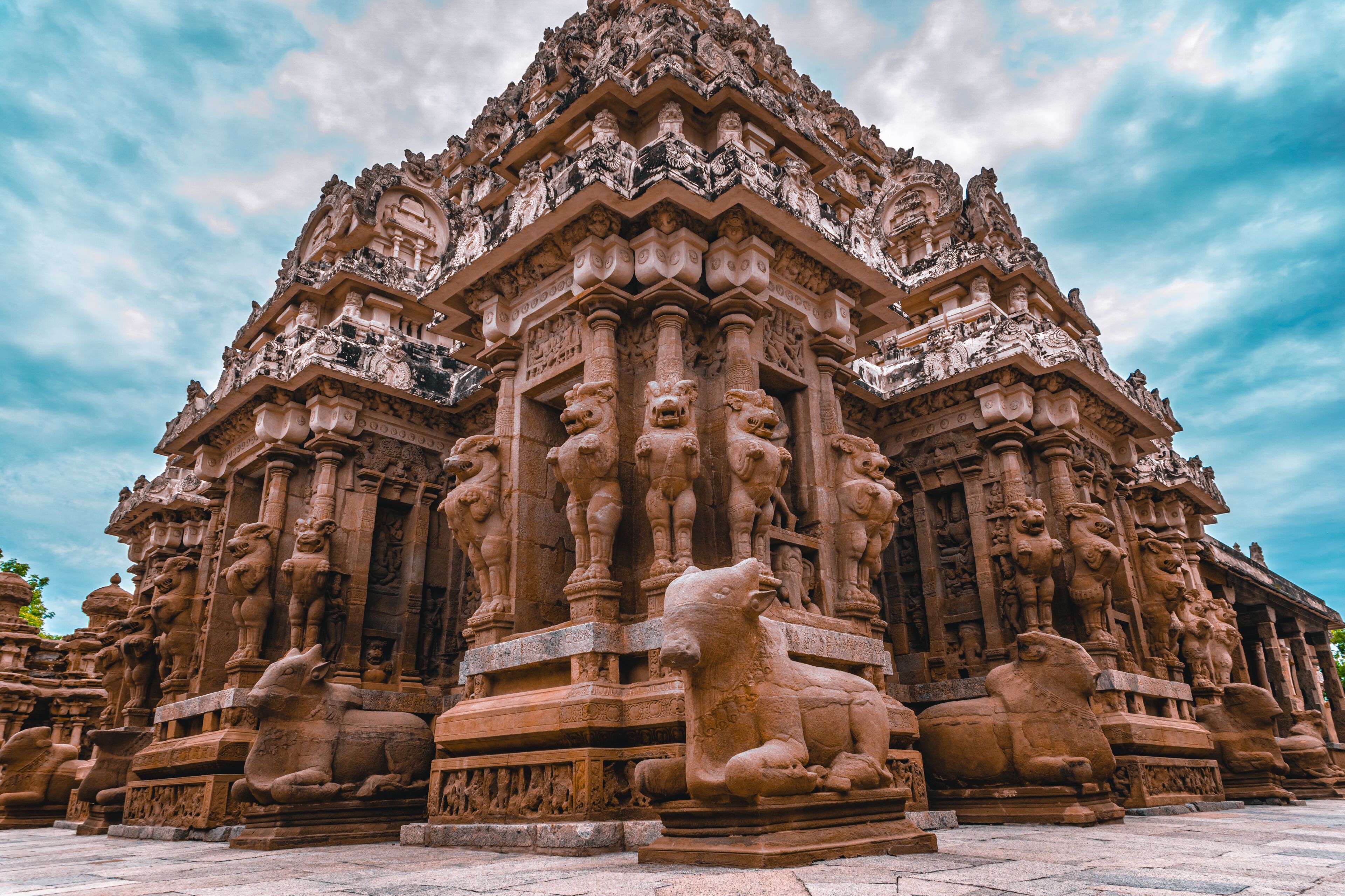 A detailed stone temple with intricate carvings and lion statues.