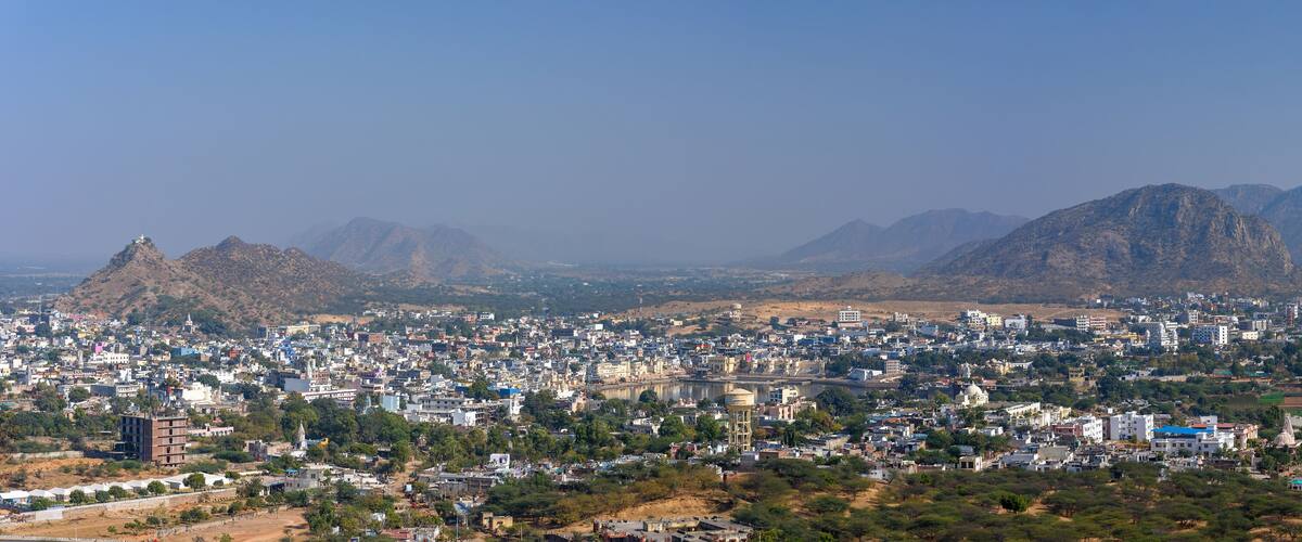 A cityscape with mountains in the background.