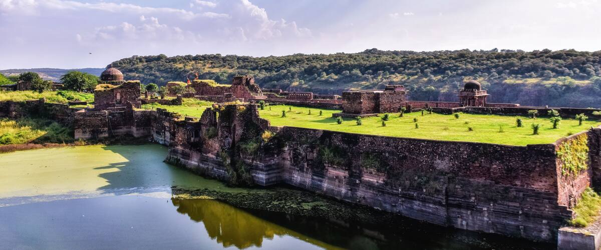 Ancient ruins with domed structures and a river.