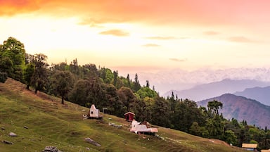 Panoramic view during sunset over snow cladded gangotri group mountain peaks falls in Greater Himalayas mountain range from Chopta, Uttarakhand, India.