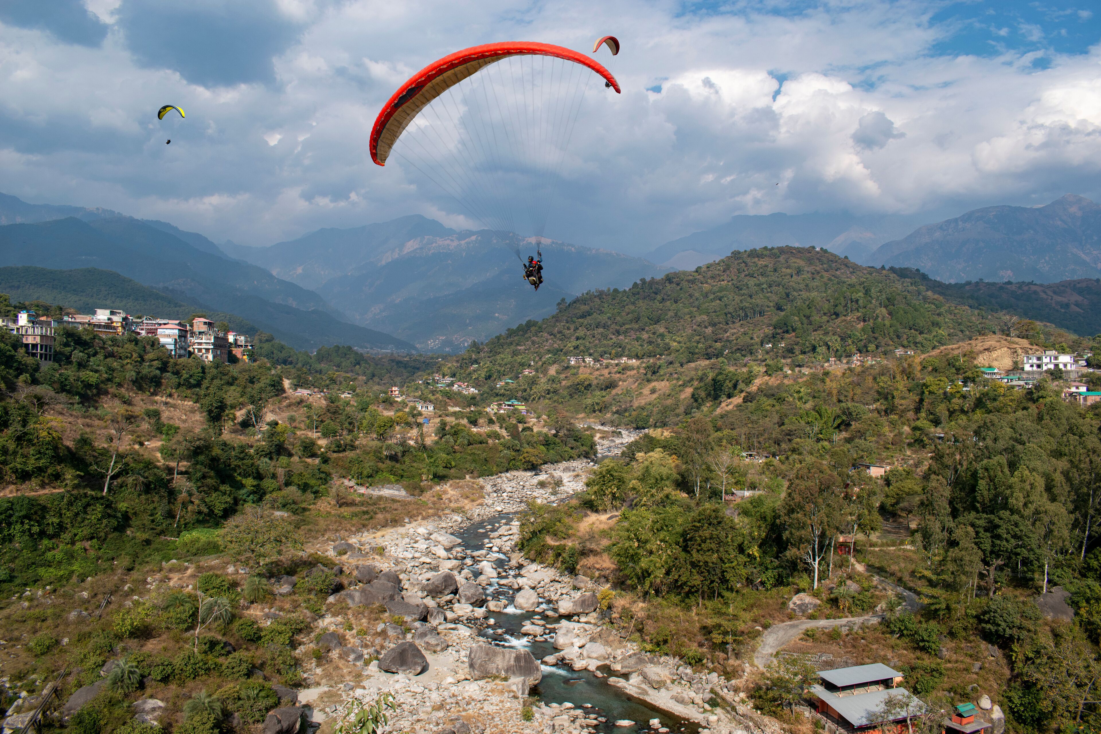 Paragliding over the clouds at Bir Billing Himachal Pradesh India. Clouds in the sky, Dhauladhar peaks view