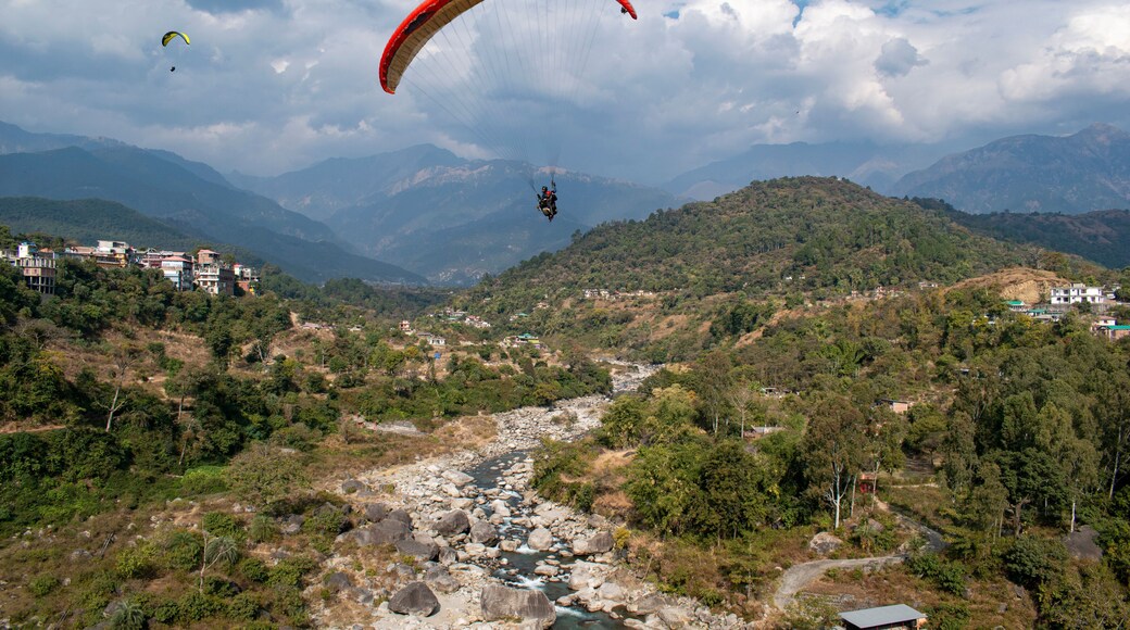 Paragliding over the clouds at Bir Billing Himachal Pradesh India. Clouds in the sky, Dhauladhar peaks view