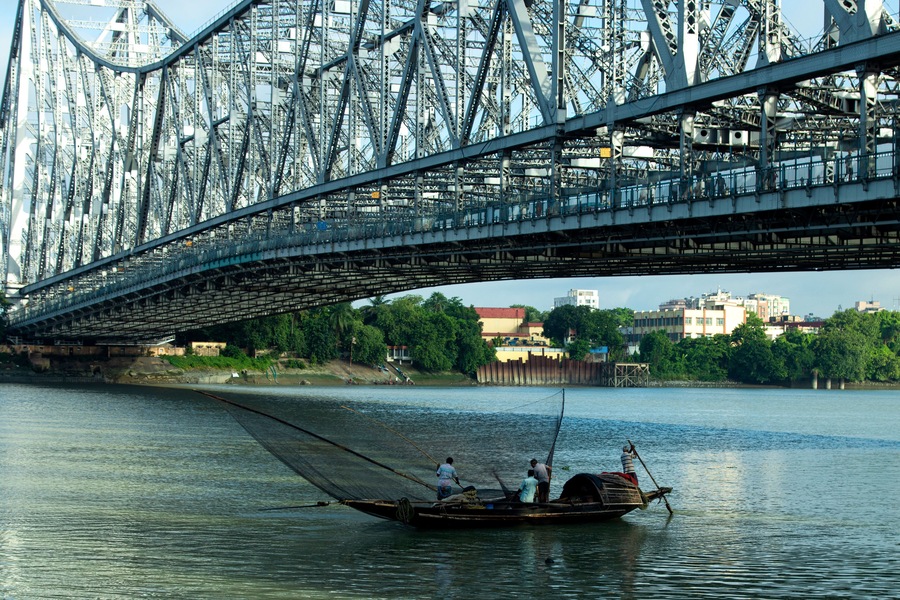 iconic Howrah bridge or Rabindra Setu of Kolkata and boat in river Ganges