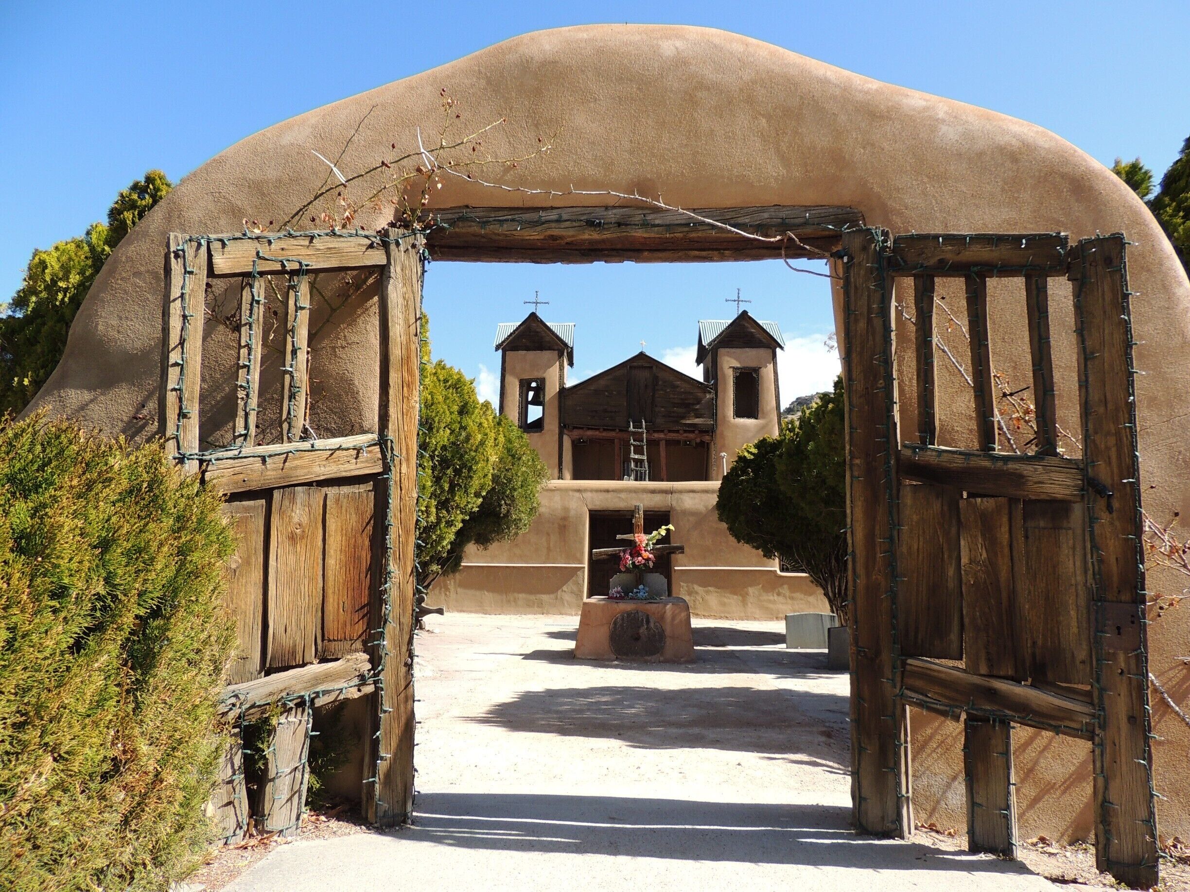 Although a classic example of Spanish Colonial architecture (thick adobe walls, two bell towers and a six-foot crucifix), the small catholic church of El Santuario de Chimaya is probably best known for its supposedly curative powers of “holy dirt” found in its sacristy. 

The National Historic Landmark, located in the Sangre de Cristo Mountains of Chimayo, has been called the “Lourdes of America”, attracting 300,000 pilgrims annually hoping to take home some of the miracle dirt.   

We went home empty handed the day of our visit; a mass was being celebrated at the time of our arrival.   

Follow the High Road to Taos Scenic Byway from Santa Fe to see this site and numerous other authentic historic landmarks.  
 
#architecture
