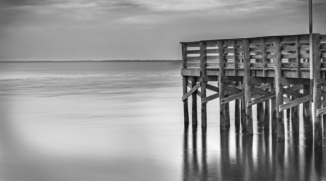 The pier extends over the calm Anclote River Park the ripples of the water provide a timeless feel. Tarpon Springs FL 2024