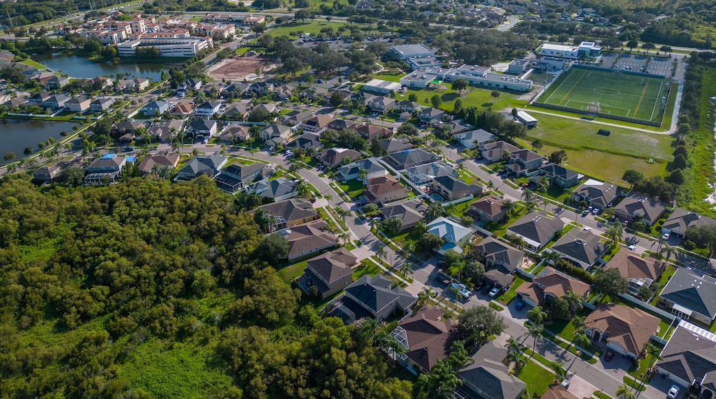 Drone shot of suburban neighborhood in New Port Richey Florida with houses and homes in sunny day