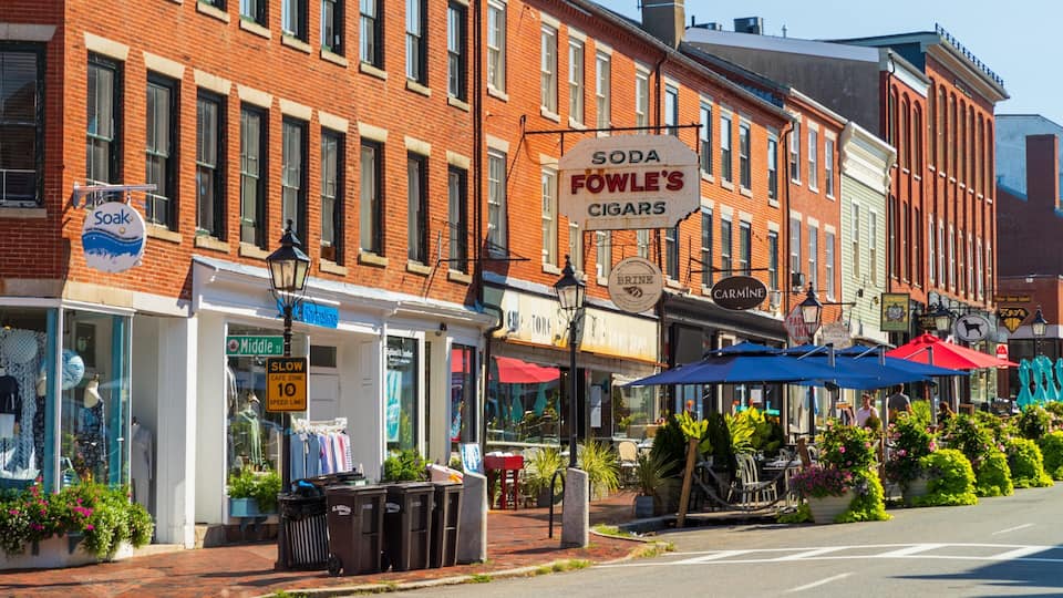 A street with brick buildings, a 'Soda Fowle's Cigars' sign, and a 'Soak' sign.