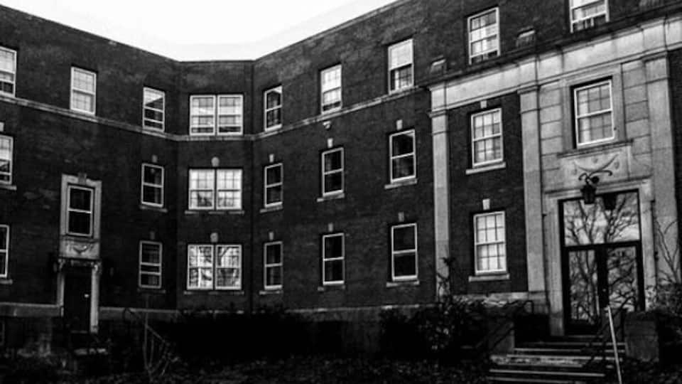 A corner building with multiple windows and a door.