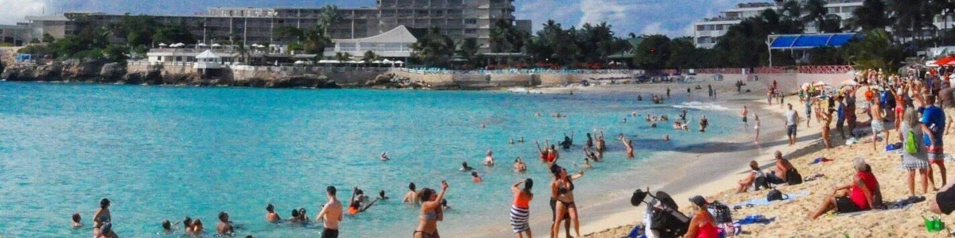 The one and only Maho Beach, Sint Maarten. Situated on the runway threshold of Princess Juliana Airport, the beach, whilst not one of the best in the Caribbean, is a great place to witness aircraft on their final approach. Passing over the beach at less than 100 feet, the aircraft jet blast frequently pushes people off the beach and into the sea.