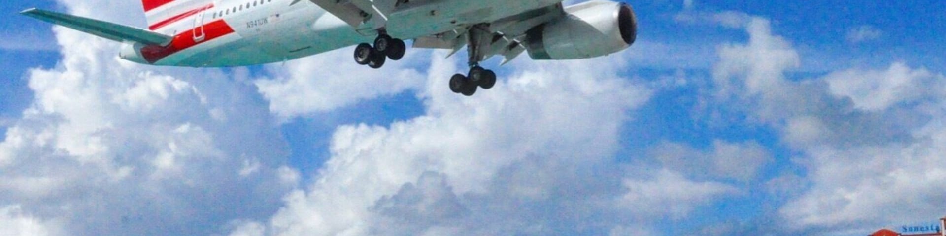 The one and only Maho Beach, Sint Maarten. Situated on the runway threshold of Princess Juliana Airport, the beach, whilst not one of the best in the Caribbean, is a great place to witness aircraft on their final approach. Passing over the beach at less than 100 feet, the aircraft jet blast frequently pushes people off the beach and into the sea.