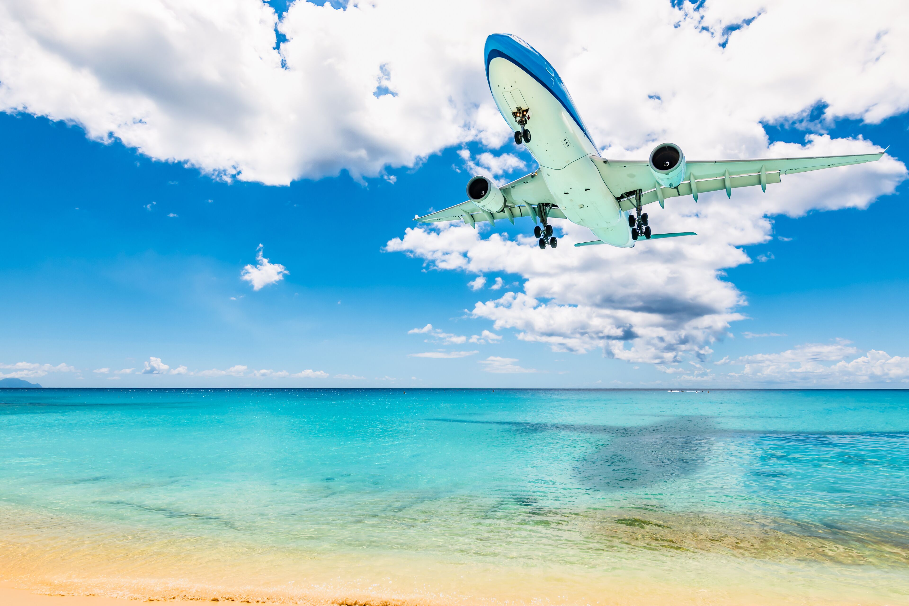 Passenger airplane above Maho beach in St Maarten, Caribbean. Travel and air transportation background.