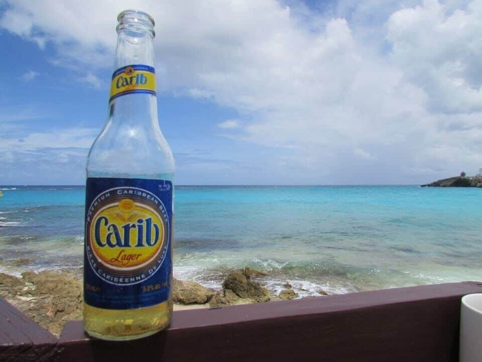 Sitting at an outdoor bar over looking Maho Beach. If you are not familiar with Maho beach it's where the planes fly ridiculously and dangerously low over a beach filled with adventure junkies anticipating a major thrill.